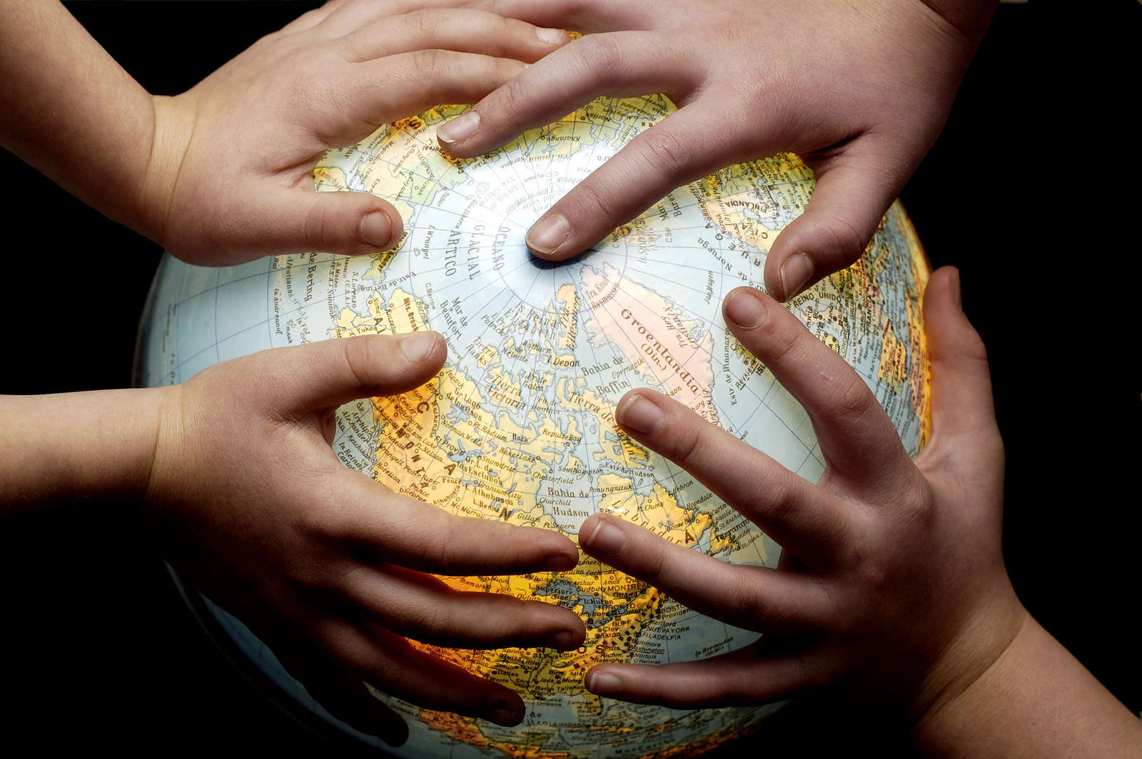 Globe and kids' hands